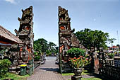 Pura Taman Ayun - Bali. The temple is accessed by a bridge guarded by the usual door guardians and the first Candi Bentar.