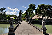 Pura Taman Ayun - Bali. The temple is accessed by a bridge guarded by the usual door guardians and the first Candi Bentar.