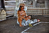 Pura Taman Ayun - Bali. Large double roofed pavilion with statues representing the a cock fighting scene.