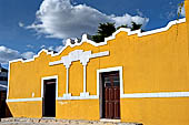 Izamal - low Spanish colonial houses, most of the buildings facades are painted a glowing ochre colour.