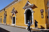 Izamal - low Spanish colonial houses, most of the buildings facades are painted a glowing ochre colour.