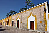 Izamal - low Spanish colonial houses, most of the buildings facades are painted a glowing ochre colour.
