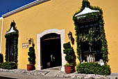 Izamal - low Spanish colonial houses, most of the buildings facades are painted a glowing ochre colour.