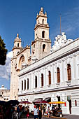 Merida the zocalo. The white Ateneo Peninsular next to the Cathedral of San Ildefonso.