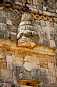 Uxmal - The Nunnery Quadrangle. The West building: frieze above wide central door with turtle-man deity on throne, round canopy above. 