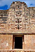 Uxmal - The Nunnery Quadrangle, the North Building. The first mask stack from left. 