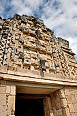 Uxmal - The Nunnery Quadrangle, the North Building. The third masks stack from left. 