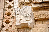 Uxmal - The Nunnery Quadrangle, the North Building. East end of the faade: stone figure of a drummer. 