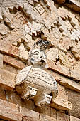 Uxmal - The Nunnery Quadrangle, the North Building. East end of the faade: stone figure of a human headed bird. 