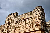 Uxmal - The Nunnery Quadrangle, the North Building. East end of the facade the fourth masks stack and the masks stack of the south-east corner. 
