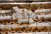 Uxmal - The Nunnery Quadrangle. The Eastern building. Detail of the trapezoidal frieze of the facade showing a owl head. 