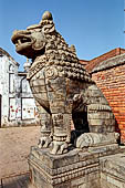 Bhaktapur - Durbar Square - details of the big lion statue at the side of a gate entrance (now of a school).