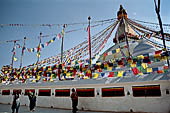 Bodhnath - Pilgrims circumambulate the external wall surrounding the stupa with 147 prayer wheels. 