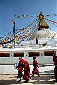 Bodhnath - Pilgrims circumambulate the external wall surrounding the stupa with 147 prayer wheels. 