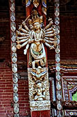 Changu Narayan - Roof Strut of first level (South facade). The wooden sculpture represents a four headed sixteen armed Vishnu Vaikuntha. Below Garuda, his mount. 