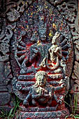Changu Narayan - Multiarmed Vishnu riding a six armed Garuda and with Laxmi on his lap (South side of the courtyard).