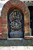 Changu Narayan - The stele with Laksmi-Narayana (XVI C) on a platform of the NE corner of the courtyard.