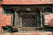 Patan Durbar Square - Detail of a wood carved window on the  Royal Palace facade.