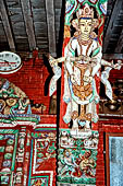 Patan - South of Durbar Square, the temple of Rato Machhendra Nath. The roof struts depict Avalokiteswara standing above figures being tortured in hell.