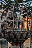 Patan - South of Durbar Square, the temple of Rato Machhendra Nath,  symbols of the Tibetan calendar on top of pillars.