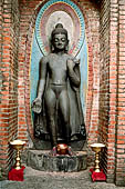 Swayambhunath Hill - black stone statue of  Dipankara, known also as the Buddha of light, standing in varadamudra.