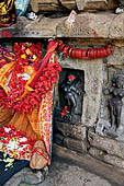 Hirapur - the Sixtyfour Yoginis Temple, Yogini n 31  Mahamaya, Yogini n 32 with raised curling hair mounted on arches with bow and arrow and on the right Yogini n 33 a graceful figure mounted on a crab. 