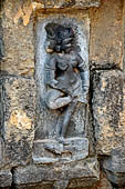 Hirapur - the Sixtyfour Yoginis Temple, Yogini n 21 (clockwise), two armed graceful figure mounted on a dog, she is adjusting her anklets. 