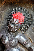 Hirapur - the Sixtyfour Yoginis Temple, head detail of Yogini n 32 (clockwise) with raised curling hair. 