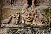 Hirapur - the Sixtyfour Yoginis Temple, detail of the pedestal of Katyayani n 4 (clockwise) with a dog and a jackal, a female attendant feeds the dog. 