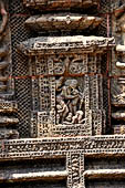 Konarak - Orissa. The Sun Temple, decorations of the platform with khakhara-mundi. The niche depict the sceneof an old mother leaving her son with the daughter in law wiping her feet.