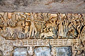 Udaigiri Cave 1 Rani Gumpha Queen's Cave - friezes of the upper storey. The Kalinga queen carried away by Ashoka. Fourth tableau: the hunt. By the sides of a tree the prince is shooting at a winged antelope. A naked woman looks down from a tree. 