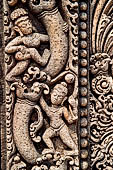Udayagiri - Monastery n1 . Decoration detail of the richly carved doorframe of the sanctum. Climbing acrobats.