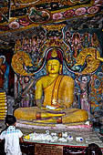 Aluvihara cave temples - Cave 1. The dragon arch overhead of the Buddha with the face of the 'Kibihi' and Hindu gods. 