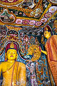 Aluvihara cave temples - Cave 1. The dragon arch overhead of the Buddha with the face of the 'Kibihi' and Hindu gods. 