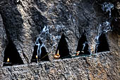 Aluvihara cave temples - Cavities in the rock boulders for oil lamps. 