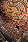 Dambulla  - Cave 2 Maharaja Vihara (Temple of the Great Kings) panels of the Defeat of Mara: Buddha is seated in bhumisparsha mudra (calling earth to witness) whilst demons attack him led by Mara  on elephant. 