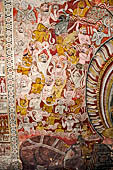 Dambulla  - Cave 2 Maharaja Vihara (Temple of the Great Kings) panels of the Defeat of Mara: Buddha is seated in bhumisparsha mudra (calling earth to witness) whilst demons attack him led by Mara  on elephant. 