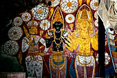 Dambulla cave temples - Cave 5, Devana Alut Viharaya (Second New Temple). On the wall behind Buddha feet the paintings of a dark Vishnu flanked by Kataragama with his peacock and Bandara (a local deity). 