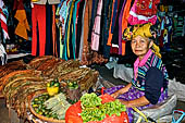 The market of Makale - stalls selling local produce including coffee, tobacco, buckets of live eels, piles of fresh and dried fish, and jugs of  'balok'