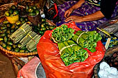 The market of Makale - stalls selling local produce including coffee, tobacco, buckets of live eels, piles of fresh and dried fish, and jugs of  'balok'