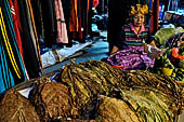 The market of Makale - stalls selling local produce including coffee, tobacco, buckets of live eels, piles of fresh and dried fish, and jugs of  'balok'