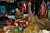 The market of Makale - stalls selling local produce including coffee, tobacco, buckets of live eels, piles of fresh and dried fish, and jugs of  'balok' 