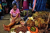 The market of Makale - stalls selling local produce including coffee, tobacco, buckets of live eels, piles of fresh and dried fish, and jugs of  'balok'