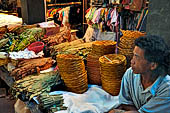 The market of Makale - stalls selling local produce including coffee, tobacco, buckets of live eels, piles of fresh and dried fish, and jugs of  'balok'