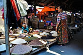 The market of Makale - stalls selling local produce including coffee, tobacco, buckets of live eels, piles of fresh and dried fish, and jugs of  'balok'
