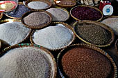 The market of Makale - stalls selling local produce including coffee, tobacco, buckets of live eels, piles of fresh and dried fish, and jugs of  'balok'