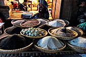 The market of Makale - stalls selling local produce including coffee, tobacco, buckets of live eels, piles of fresh and dried fish, and jugs of  'balok'