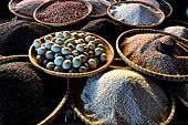 The market of Makale - stalls selling local produce including coffee, tobacco, buckets of live eels, piles of fresh and dried fish, and jugs of  'balok'