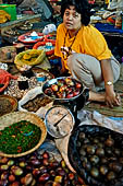 The market of Makale - stalls selling local produce including coffee, tobacco, buckets of live eels, piles of fresh and dried fish, and jugs of  'balok'