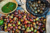 The market of Makale - stalls selling local produce including coffee, tobacco, buckets of live eels, piles of fresh and dried fish, and jugs of  'balok'